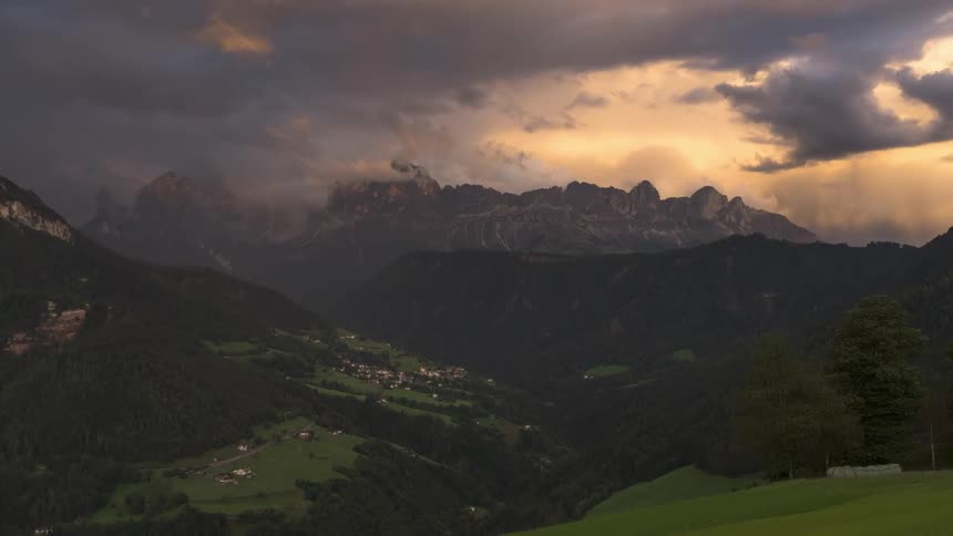 Landscape of green mountains in the late afternoon with dense and hazy clouds