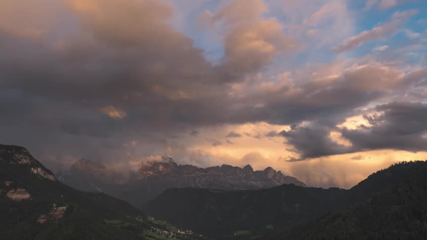 Heavy clouds cast shade on the mountain range