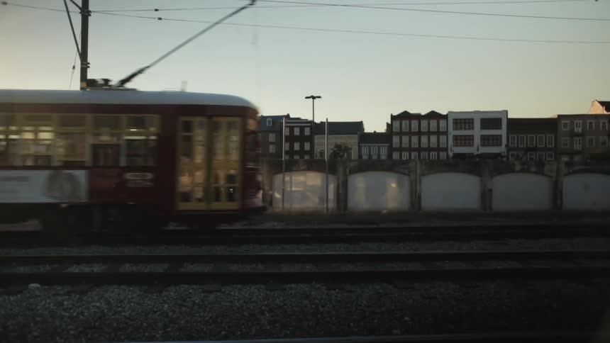 Train traveling on tracks in city