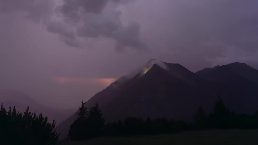 Thunder on a cloudy day over the mountains silhouette