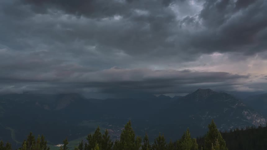 Heavy clouds and fog cover the valley