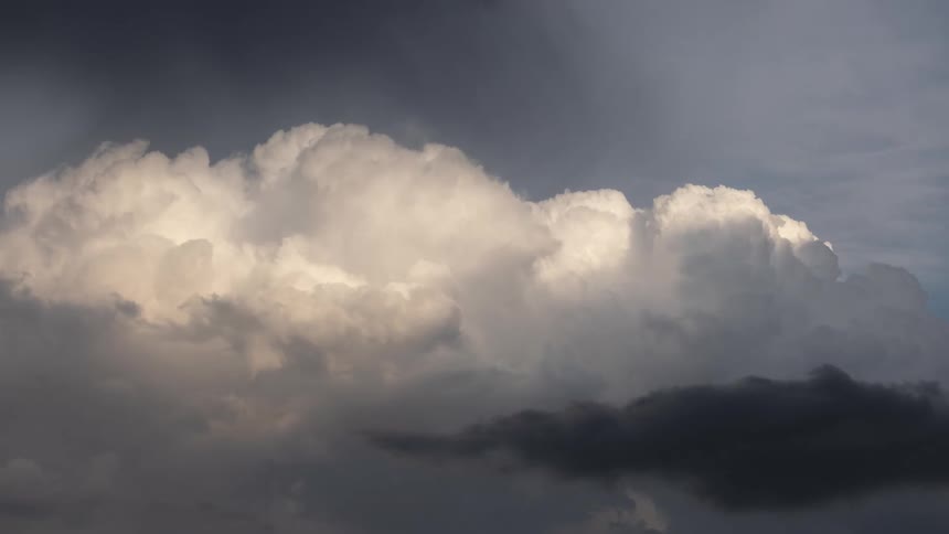 White and black clouds are moving in the sky via a time lapse
