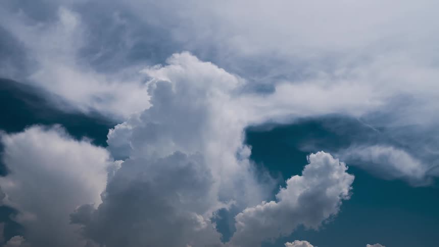 Big cloud banks twist and flow in the blue sky