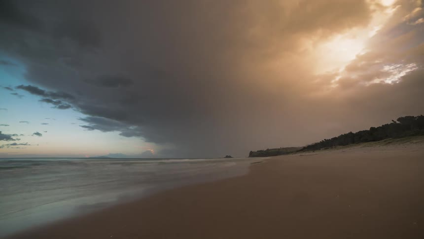 Beach at dusk with dark clouds with storm