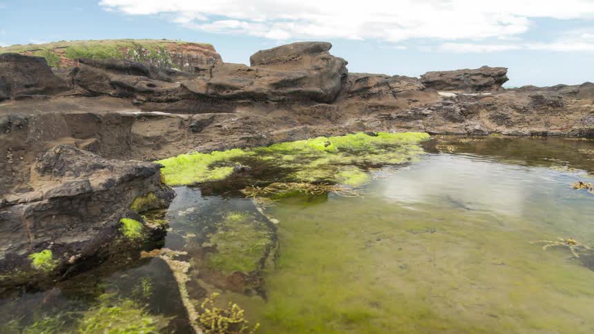 Lake surrounded by rocks by the sea