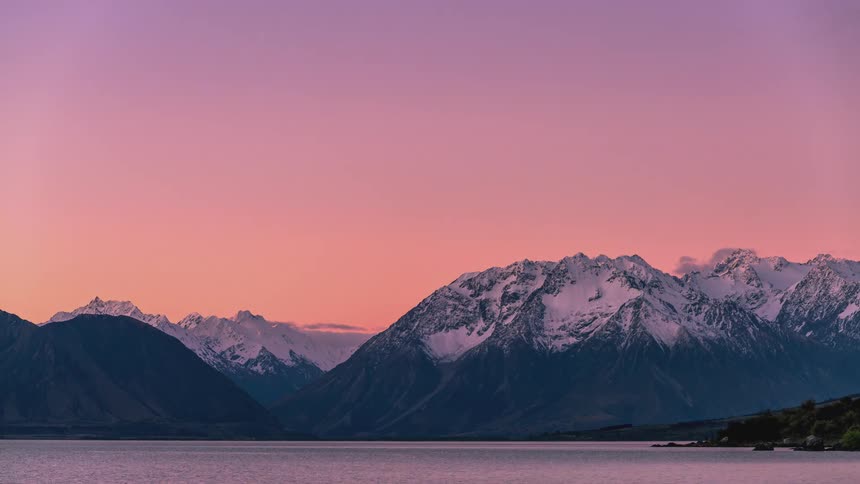 Time lapse of the transition from dusk to night over a lake in the mountains