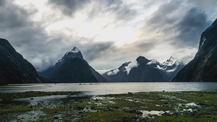 A lake sits in the middle of the mountains