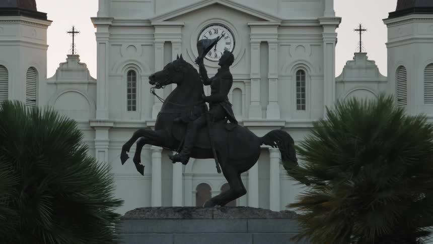 A statue of a man on a horse is in front of this building