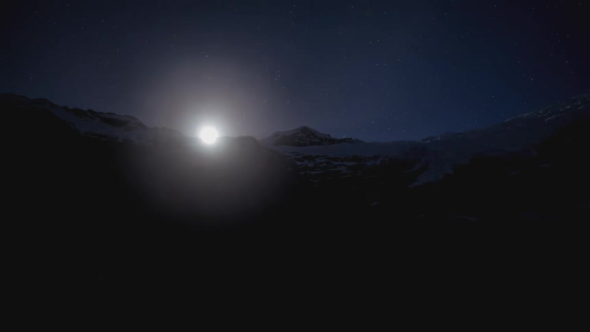 Time lapse of a full moon over the mountains on a starry sky