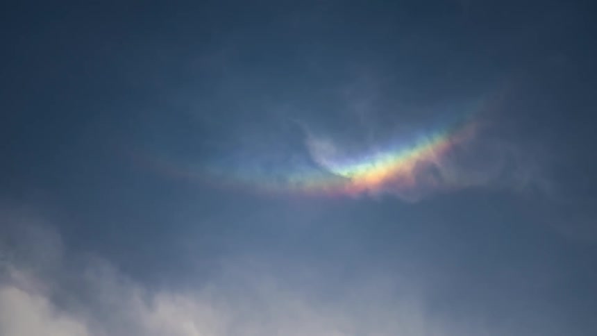 Sky with clouds and the reflection of a rainbow