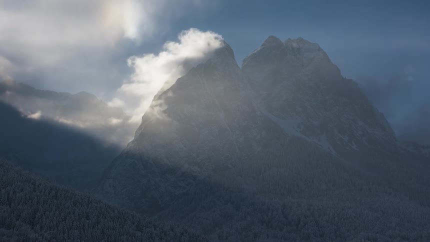 Mountains with forests around and the reflection of natural sunlight