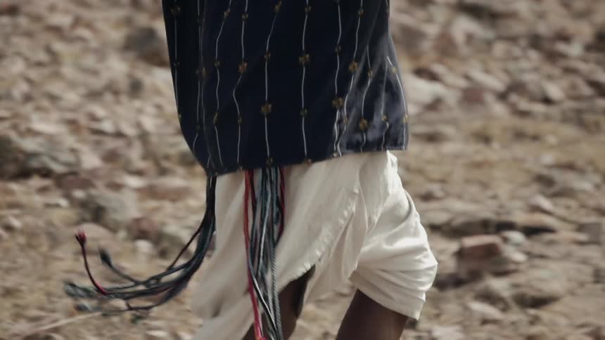 A person is running in the rocks of a desert