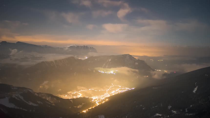 Night landscape of a mountainous region with city lights in the background