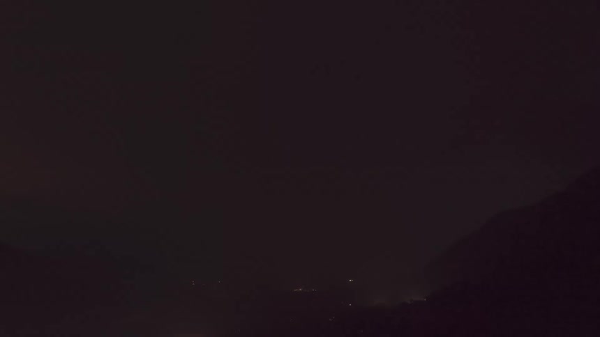 A lightning storm in a dark sky with bright clouds in the glow of lightning