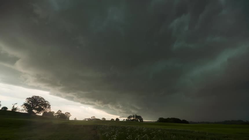 Time lapse of a large storm clouds rolling over a rural landscape