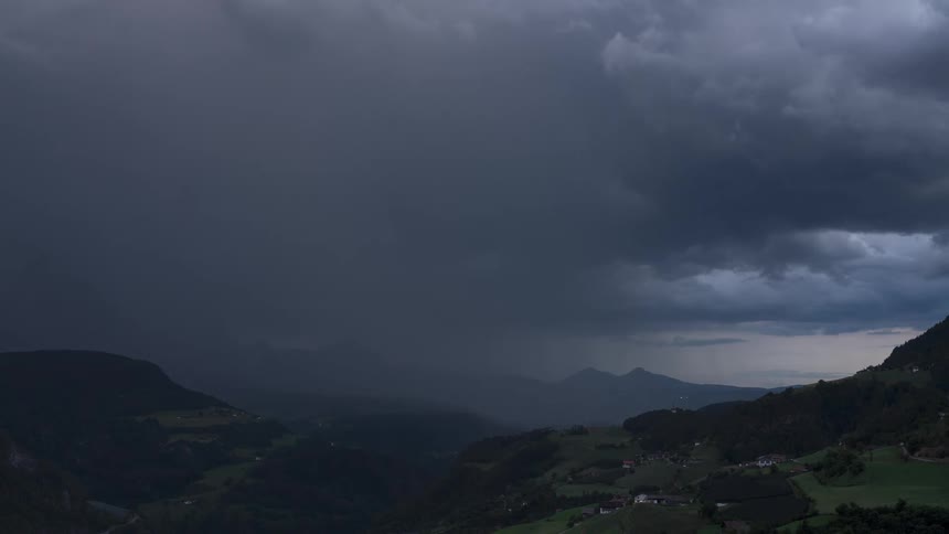 Panorama of mountain ranges and black clouds passing by