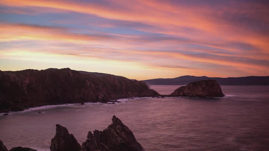 Silhouette landscape of the coast by the sea and the day dawning