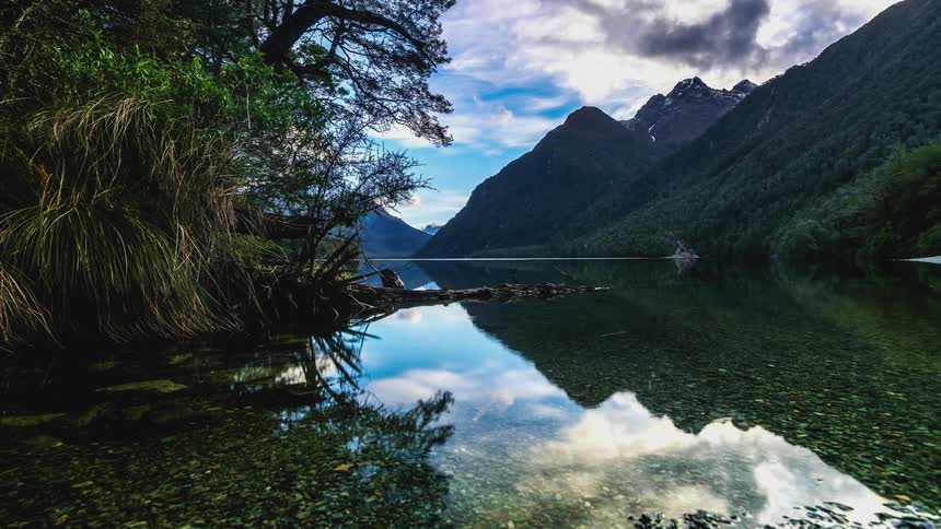 Crystal clear lake surrounded by green mountains