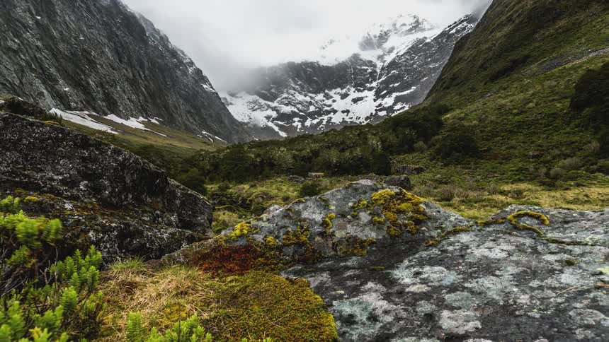 The mountains ahead are covered with snow and ice
