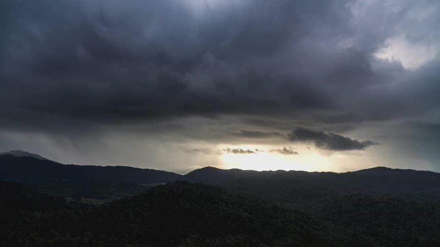 Time lapse of clouds rolling over a mountainous landscape