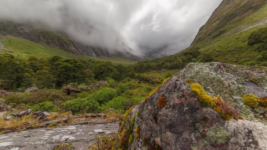 A timelapse of clouds rolling over some mountains