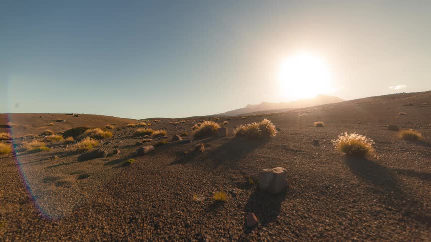 Landscape of an army hill with a sun setting on the horizon