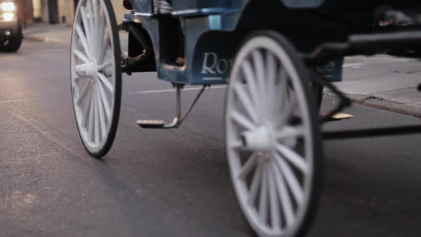 A horse drawn carriage going down a city street