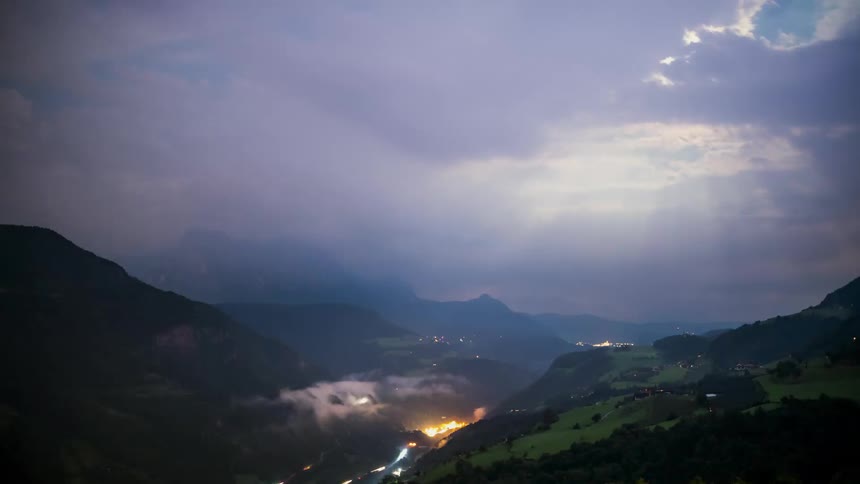Landscape of sunlight passing through the clouds above the mountains in a late afternoon