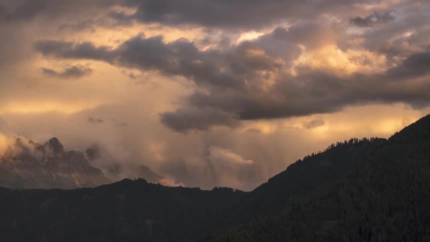 Panorama of mountain ranges with rainbows and a cloudy sky