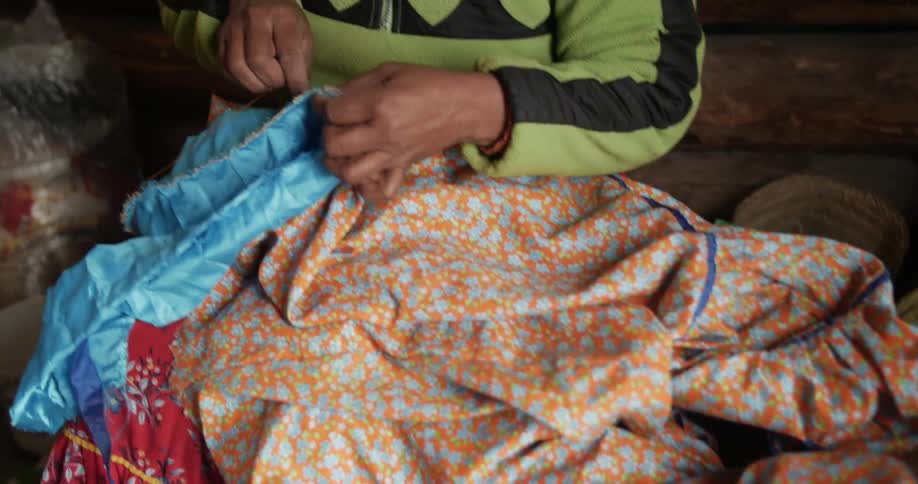 A woman folds a piece of cloth