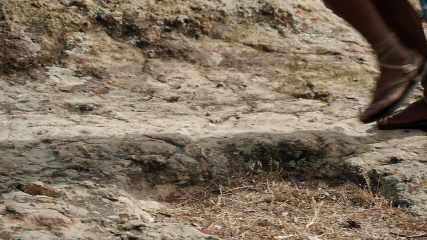 A man runs along the rocks in slippers
