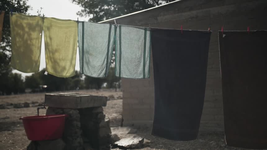 Towels hanging off of a clothes line