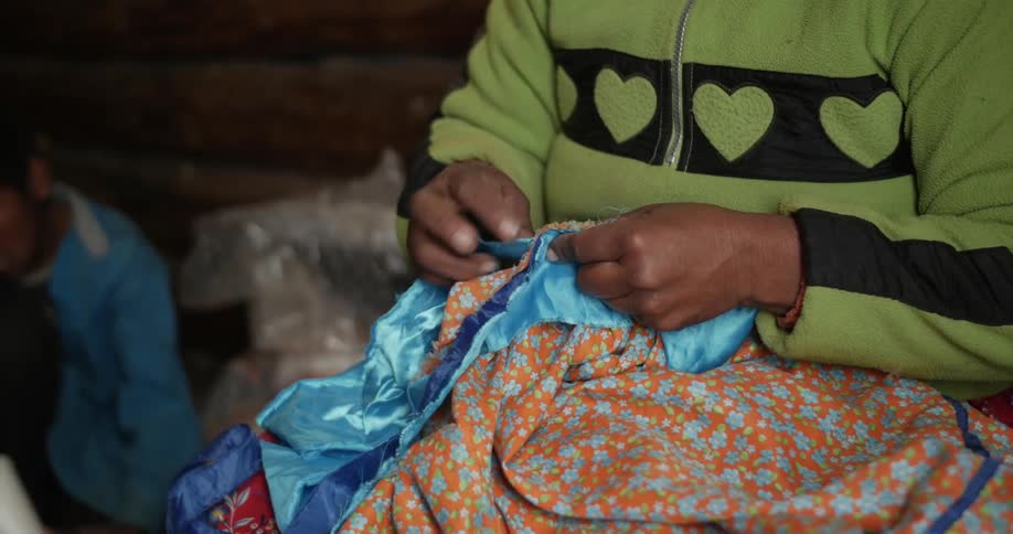 A woman examines a piece of cloth