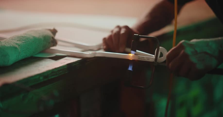 A worker seals a fluorescent light tube