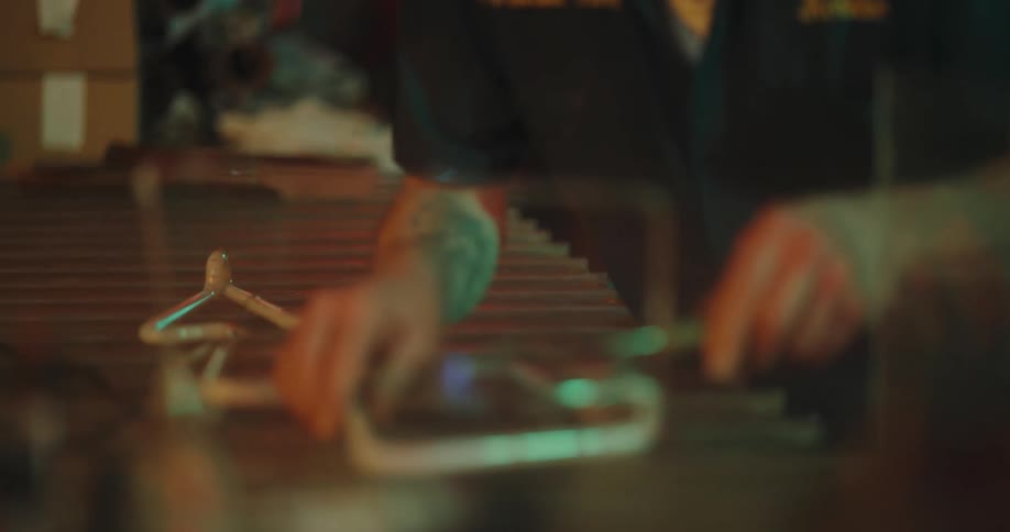 A man in a neon factory using heat to shape and seal neon lights