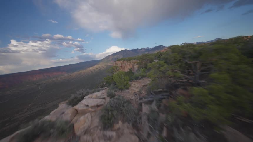 Aerial landscape of a canyon with vegetation on a partly cloudy day