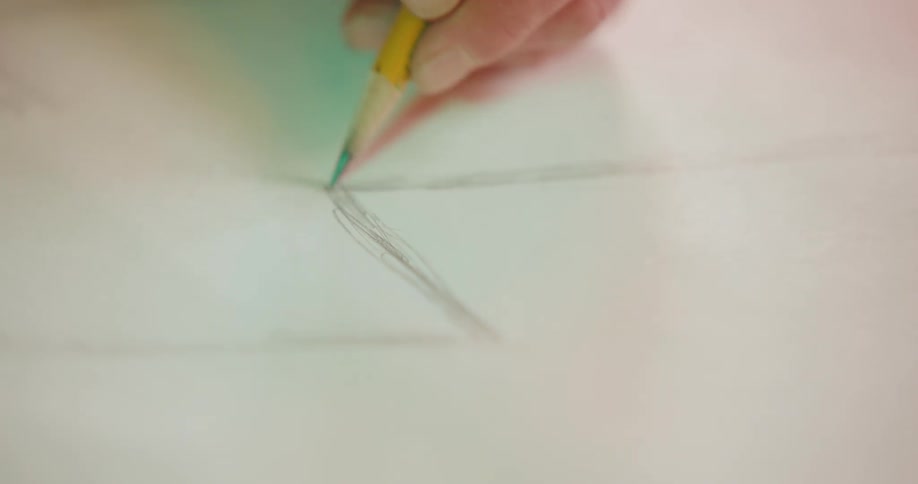 Hand holding a pencil and drawing a lightning bolt on a paper