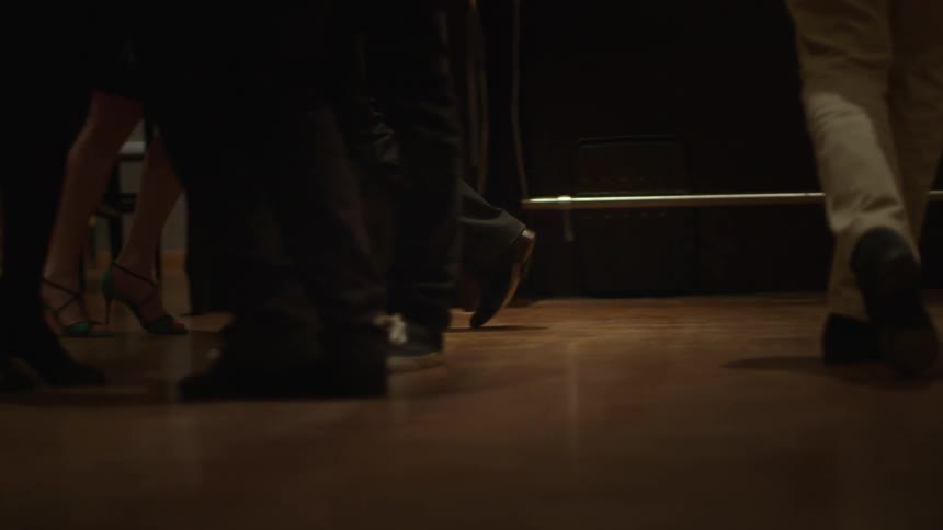 A group of people dance in a ballroom