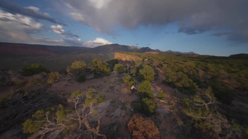 Aerial view of someone bicycling on a plateau