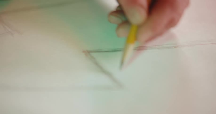 A man sketches on a large piece of paper