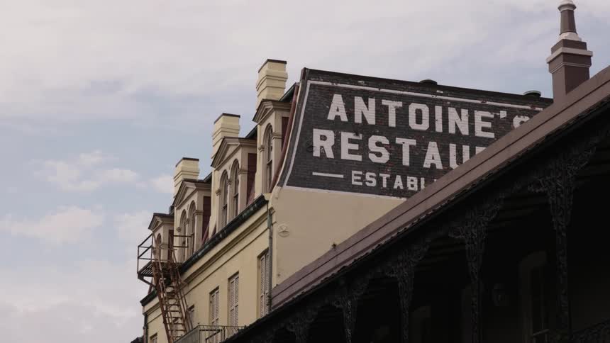 Restaurant sign on building in city