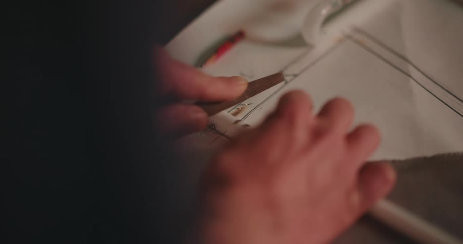 Hands of a person sawing a glass tube
