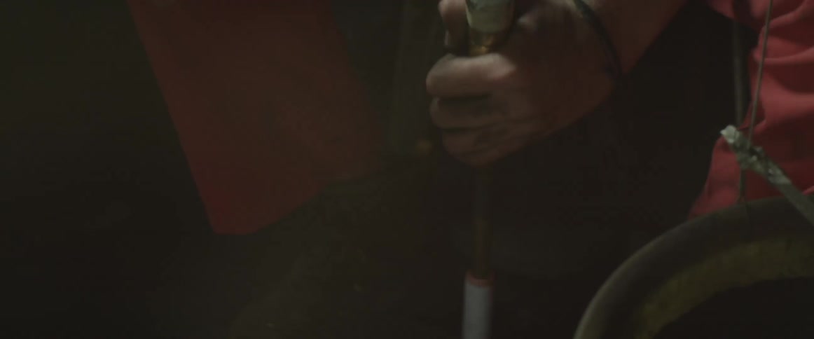 A person is working in a shop hammering something