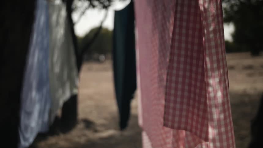 Clothing on a clothesline swaying gently in the wind