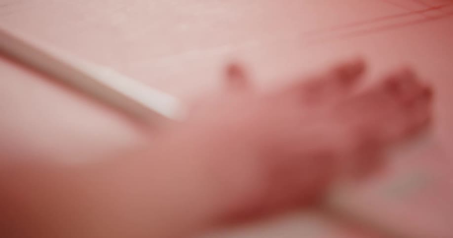 Person marks a large sheet of paper using a pencil and a straight edge