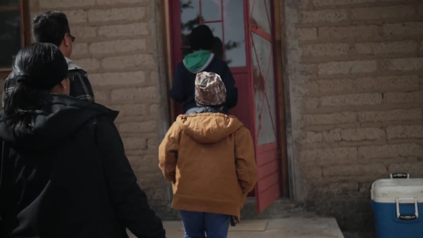 A family enters a house