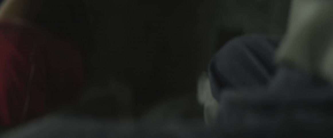 Man hammering in a dark room