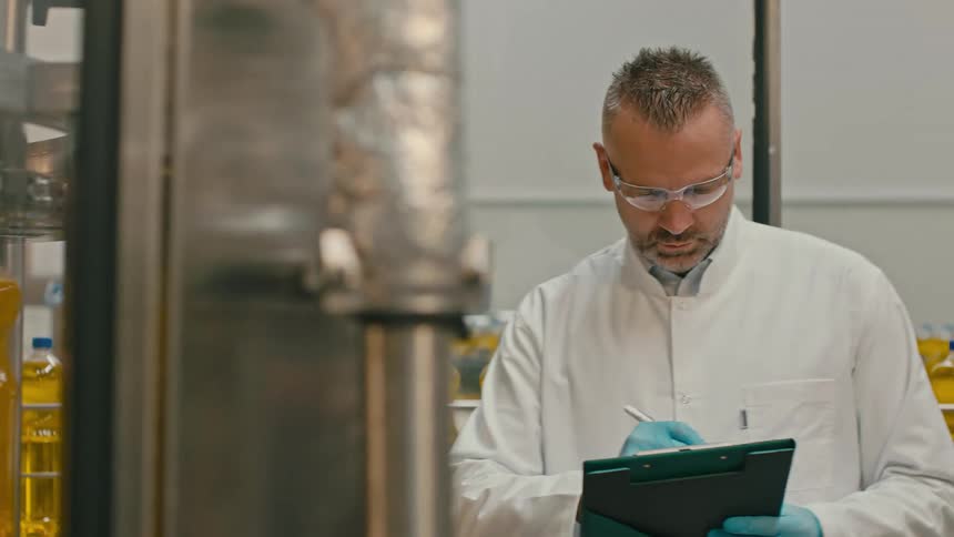 Bottles of cooking oil are filled in the factory