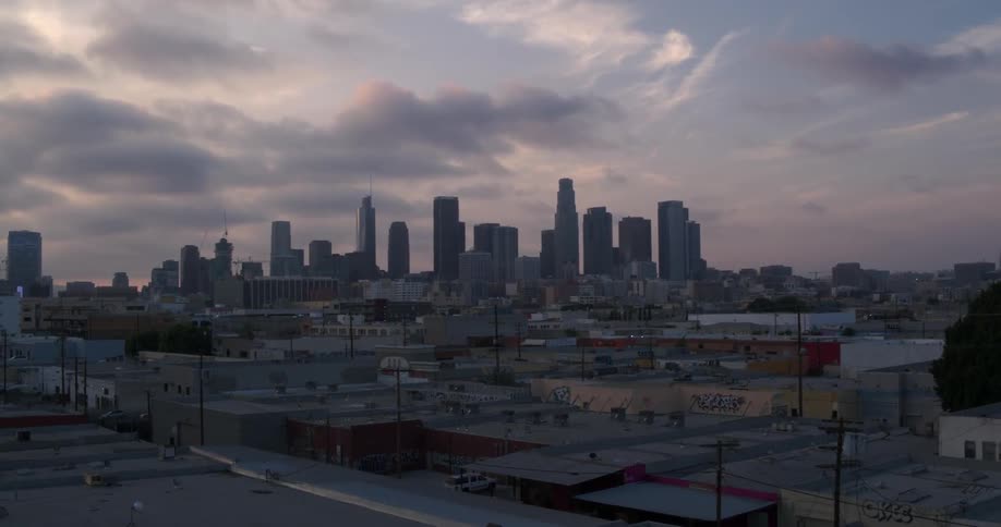 There are heavy clouds above the city ahead at sunset