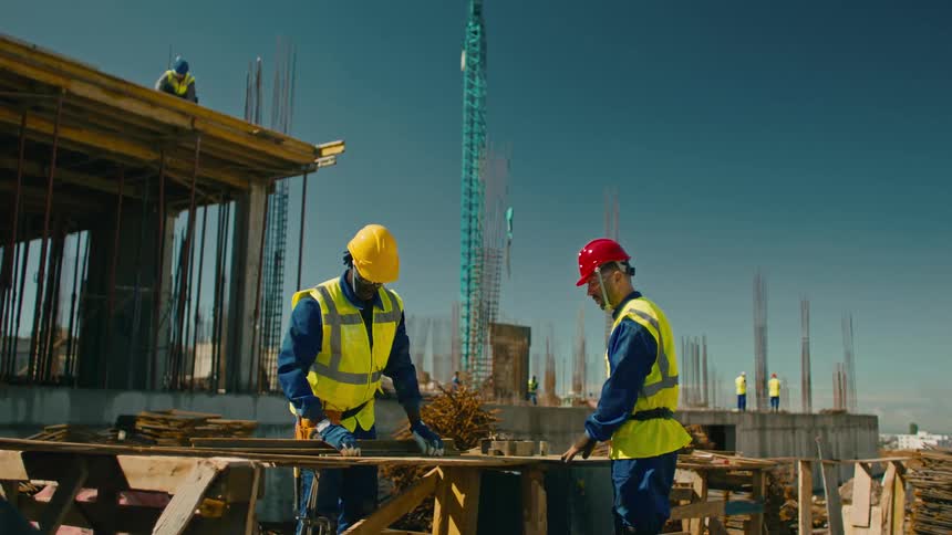 Construction workers wearing specific clothing and helmets
